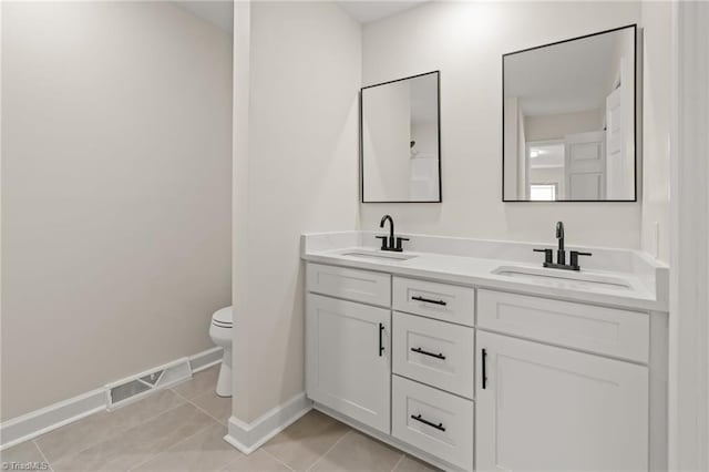 135 Boxwood Cir, Advance, NC 27006 - bathroom featuring double vanity, baseboards, toilet, and tile patterned floors