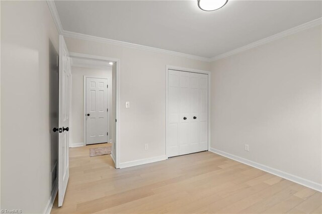 135 Boxwood Cir, Advance, NC 27006 - unfurnished bedroom featuring light wood-style flooring, ornamental molding, baseboards, and a closet