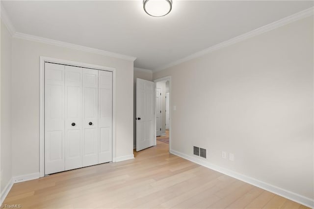 135 Boxwood Cir, Advance, NC 27006 - unfurnished bedroom featuring light wood-style floors, baseboards, a closet, and ornamental molding