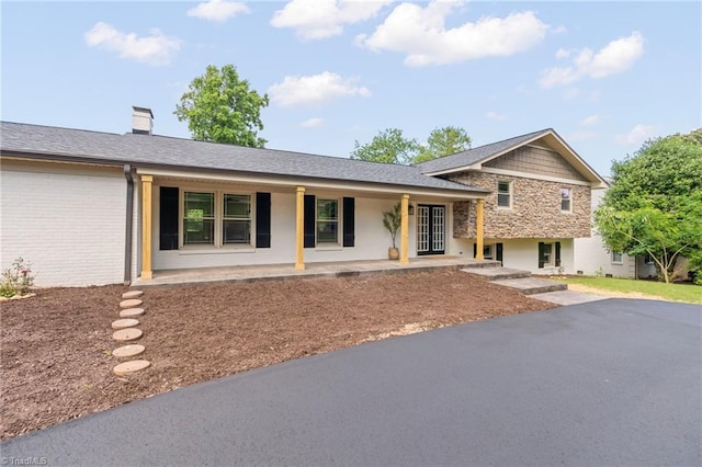 135 Boxwood Cir, Advance, NC 27006 - split level home with covered porch, a chimney, and brick siding