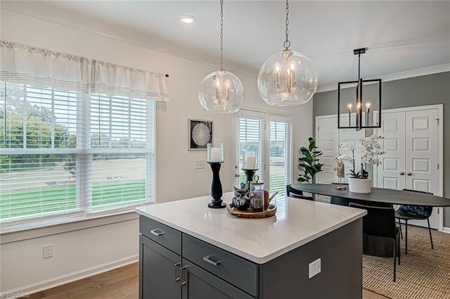 5927 Clouds Harbor Trl, Clemmons, NC 27012 - kitchen with a chandelier, gray cabinetry, baseboards, light countertops, and ornamental molding