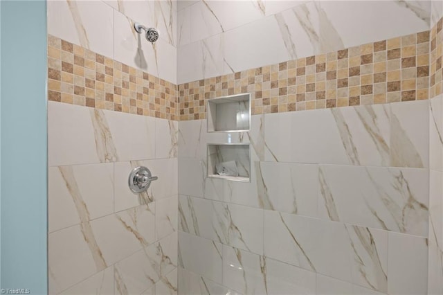 full bath featuring tiled shower