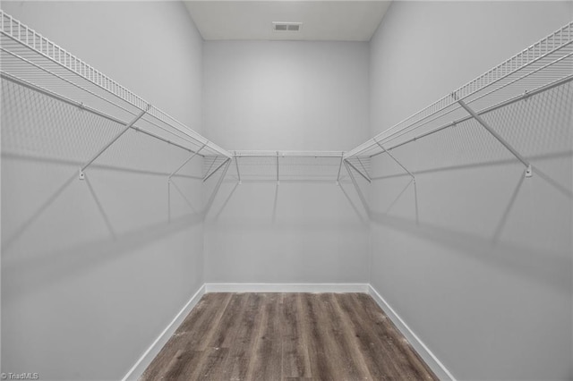 walk in closet with wood finished floors and visible vents