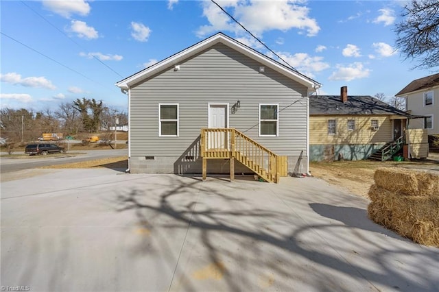 rear view of property with crawl space