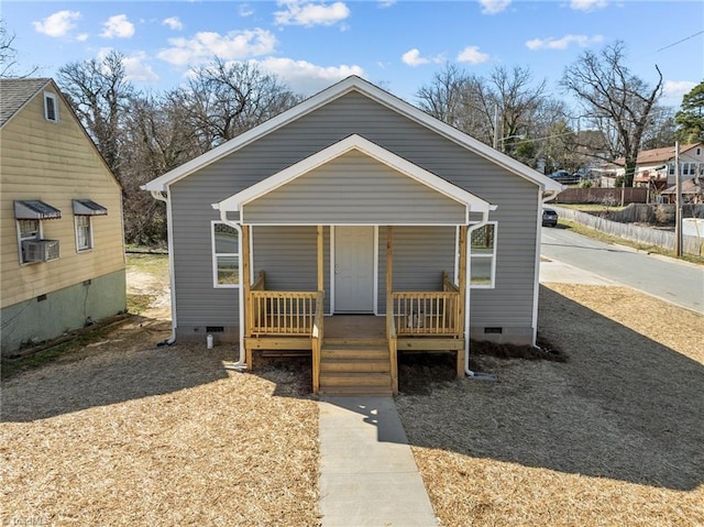 bungalow with crawl space, covered porch, and cooling unit