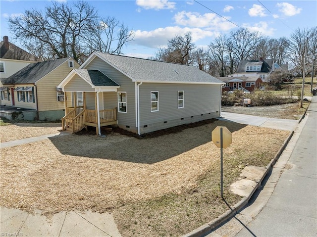 view of front of property featuring crawl space and a shingled roof