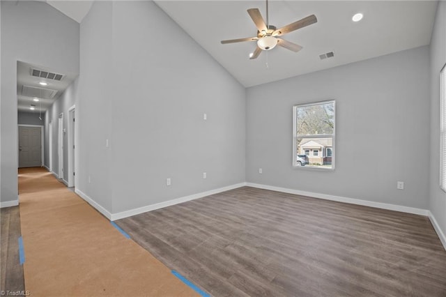 spare room with visible vents, ceiling fan, attic access, and baseboards