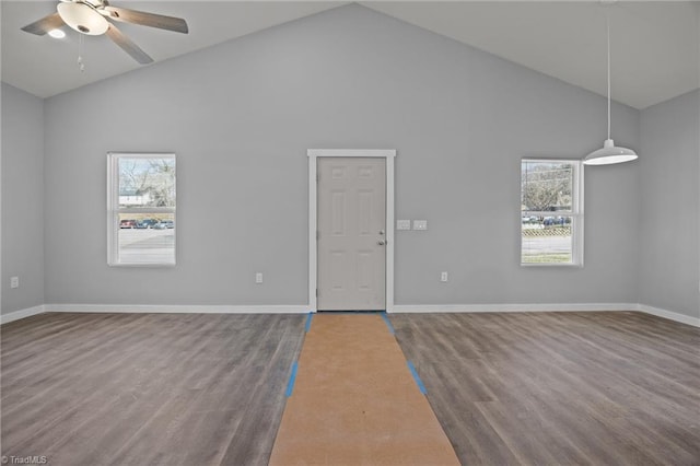 spare room featuring ceiling fan, baseboards, plenty of natural light, and wood finished floors