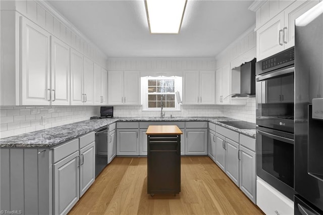 kitchen featuring gray cabinets, light hardwood / wood-style flooring, crown molding, and black appliances