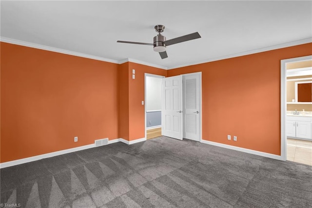 unfurnished bedroom with ensuite bath, ceiling fan, sink, crown molding, and carpet floors