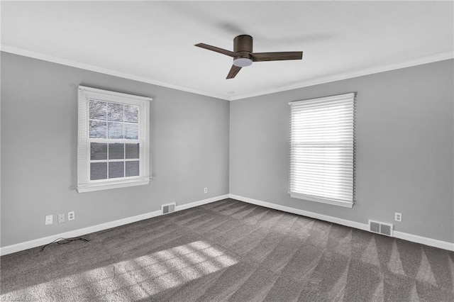 spare room with dark carpet, ceiling fan, and ornamental molding