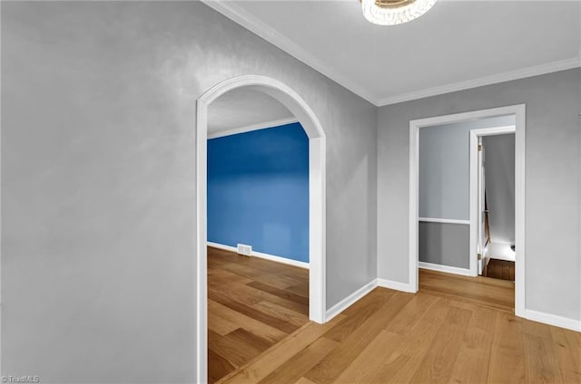 hall featuring crown molding and light hardwood / wood-style flooring