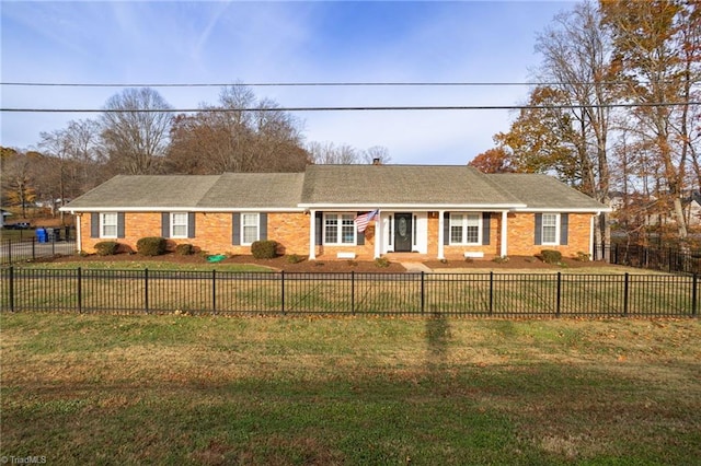 single story home featuring a front lawn