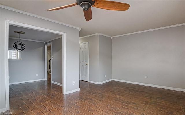 empty room with ceiling fan with notable chandelier, dark hardwood / wood-style floors, and ornamental molding