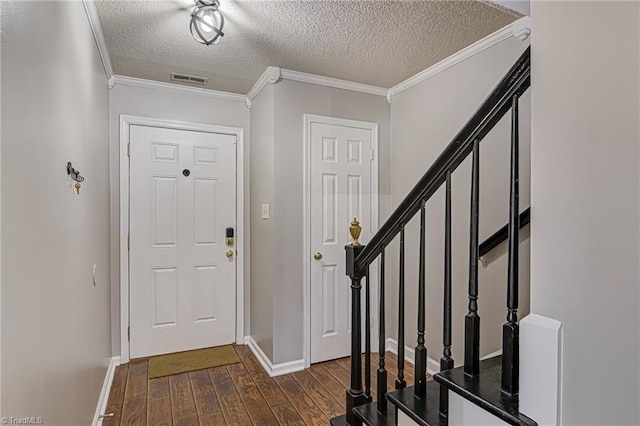 entryway featuring crown molding, dark hardwood / wood-style flooring, and a textured ceiling