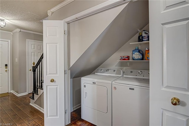 washroom featuring dark hardwood / wood-style floors, separate washer and dryer, a textured ceiling, and ornamental molding