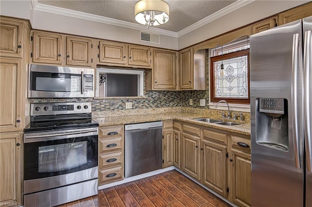 kitchen with sink, stainless steel appliances, light stone counters, dark hardwood / wood-style floors, and crown molding