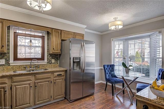 kitchen with crown molding, sink, dark hardwood / wood-style flooring, light stone counters, and stainless steel fridge with ice dispenser