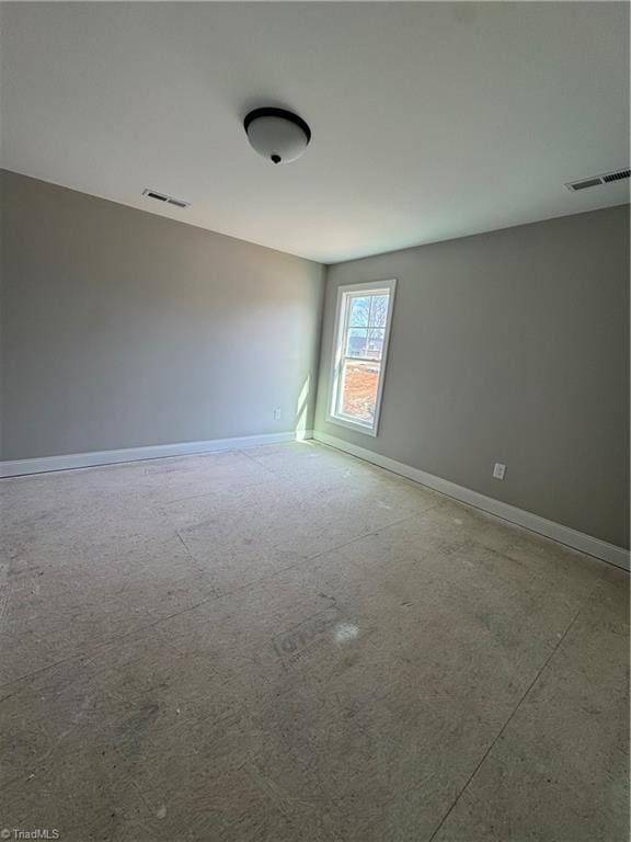 empty room featuring visible vents and baseboards