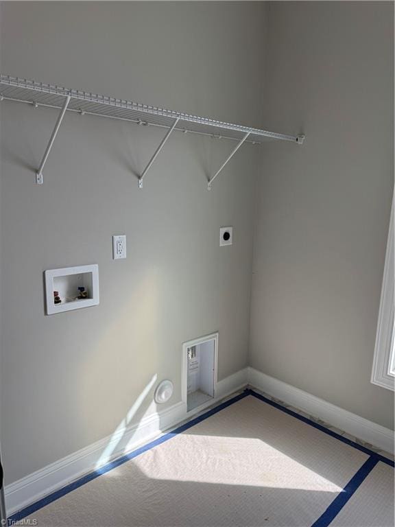 laundry area with laundry area, hookup for an electric dryer, and baseboards