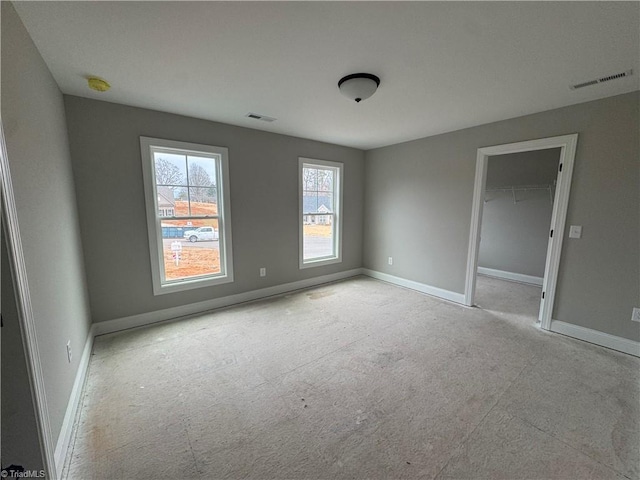 spare room featuring baseboards and visible vents