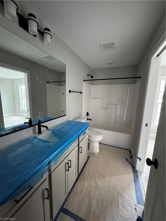 full bathroom with visible vents, toilet, washtub / shower combination, and vanity