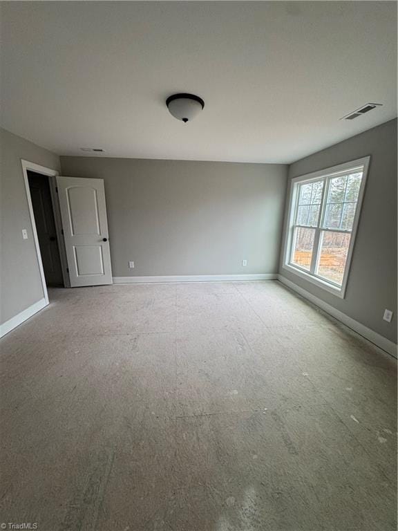 unfurnished room featuring visible vents and baseboards