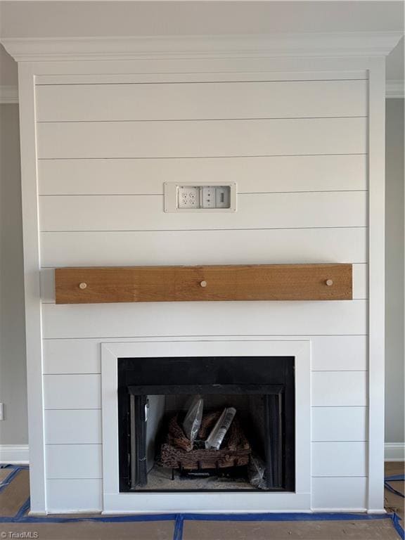 details featuring crown molding and a fireplace