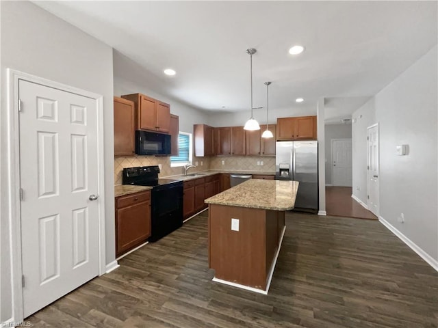 kitchen with dark wood-type flooring, sink, black appliances, a kitchen island, and hanging light fixtures