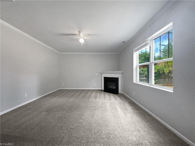 unfurnished living room with ceiling fan, carpet, and ornamental molding