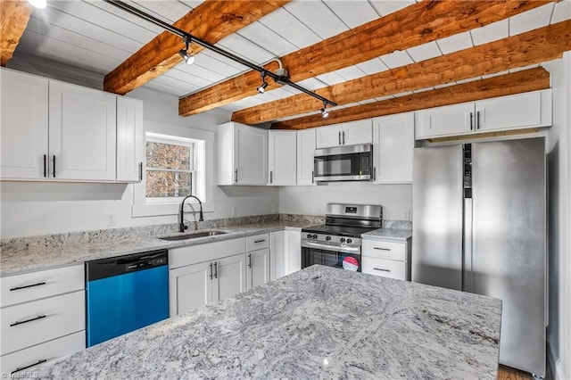 kitchen featuring wood ceiling, appliances with stainless steel finishes, light stone counters, a sink, and beam ceiling