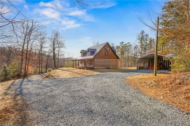 view of front of home featuring a carport and gravel driveway