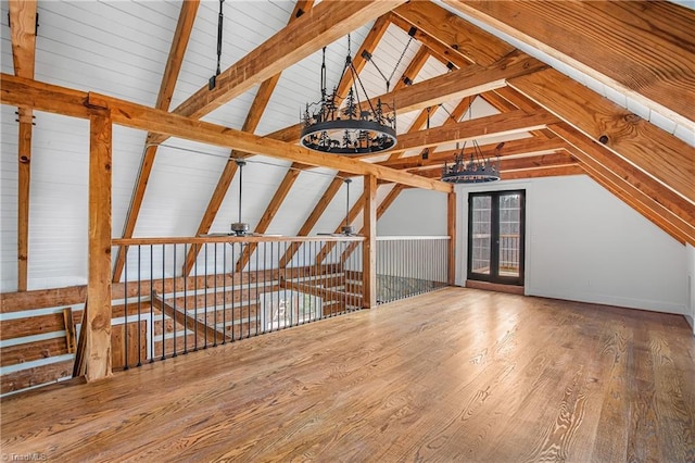 bonus room featuring vaulted ceiling with beams, a ceiling fan, and wood finished floors