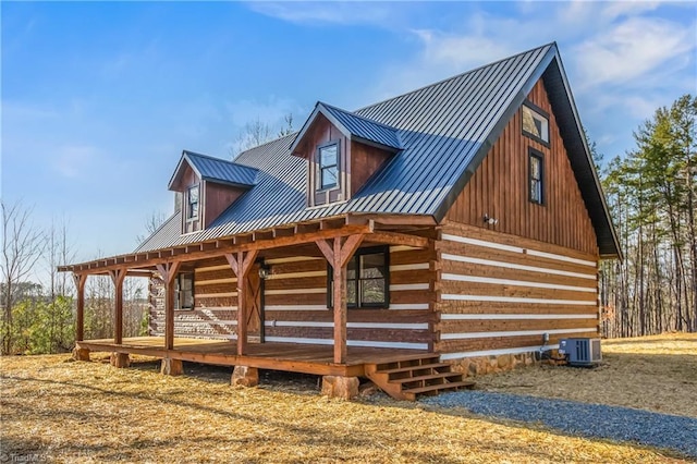 exterior space with a porch, a standing seam roof, central AC, and metal roof