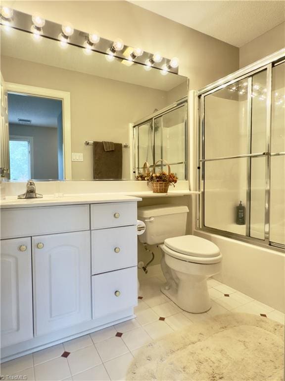 606 Dorado Cir, High Point, NC 27265 - bathroom featuring toilet, tile patterned flooring, vanity, and bath / shower combo with glass door
