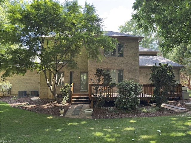 606 Dorado Cir, High Point, NC 27265 - rear view of property featuring brick siding, a lawn, a wooden deck, and central air condition unit