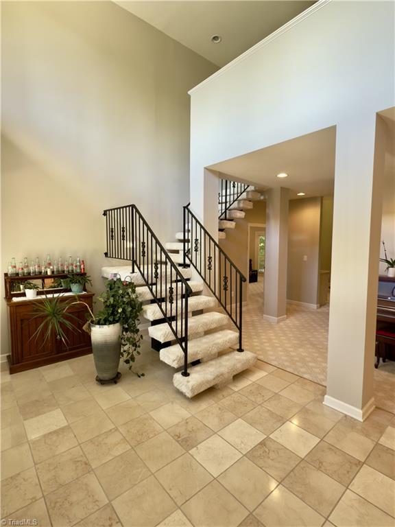 606 Dorado Cir, High Point, NC 27265 - stairs featuring a high ceiling and baseboards