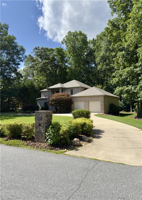 606 Dorado Cir, High Point, NC 27265 - view of front of home with driveway, a garage, a front yard, and view of scattered trees
