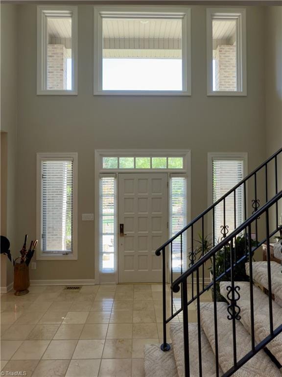 606 Dorado Cir, High Point, NC 27265 - foyer entrance with a high ceiling, baseboards, stairway, light tile patterned floors, and healthy amount of natural light