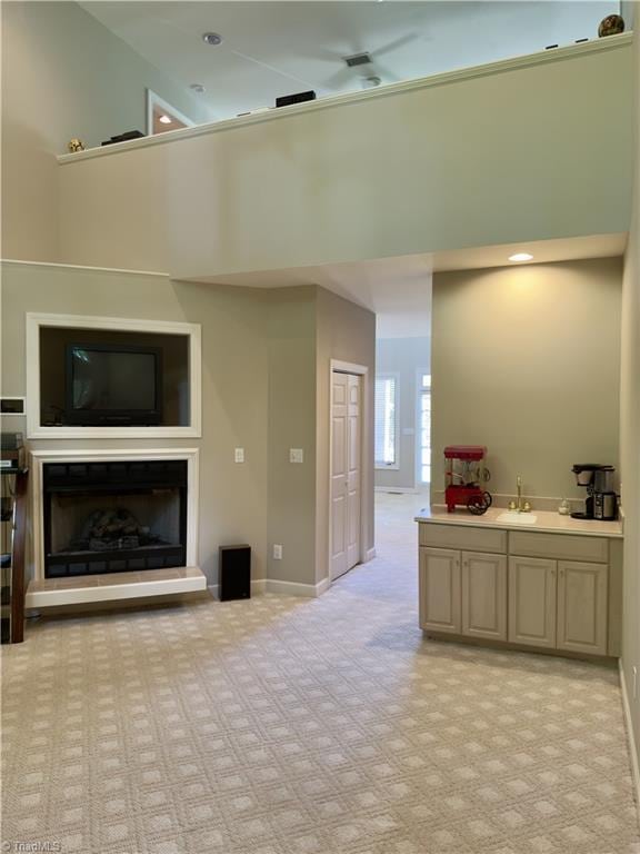 606 Dorado Cir, High Point, NC 27265 - living room with a high ceiling, light colored carpet, baseboards, and a fireplace with raised hearth