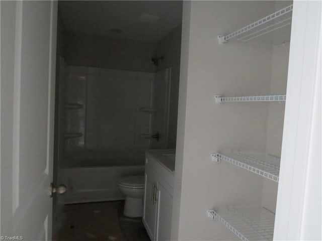 full bathroom featuring washtub / shower combination, vanity, and toilet