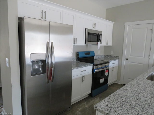 kitchen with white cabinetry, light stone counters, and appliances with stainless steel finishes