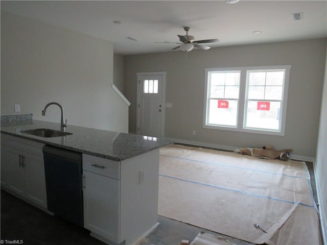 kitchen with white cabinetry, black dishwasher, light stone countertops, sink, and ceiling fan