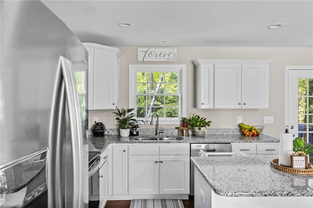 kitchen with white cabinets, a healthy amount of sunlight, stainless steel appliances, and sink