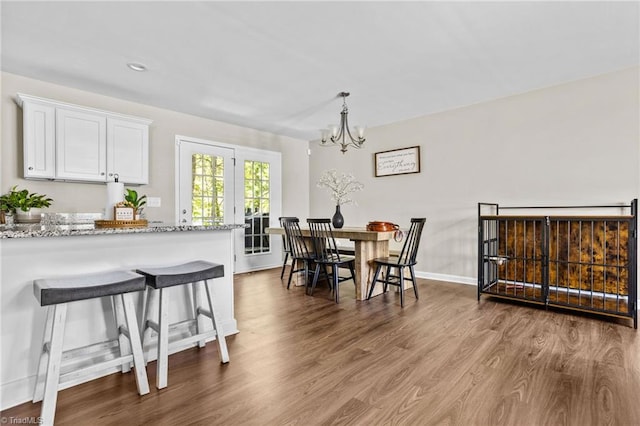 dining room with an inviting chandelier and hardwood / wood-style floors