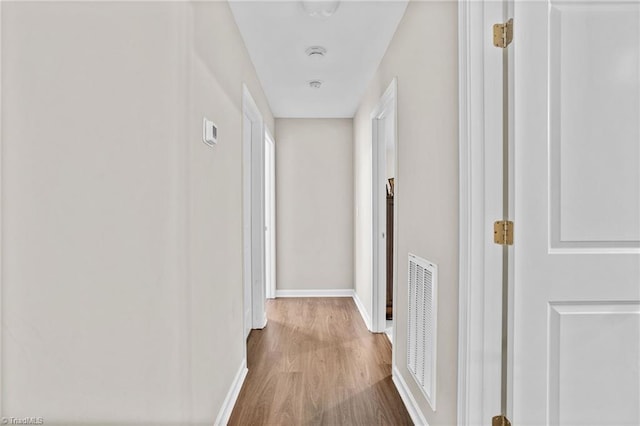 corridor with hardwood / wood-style floors