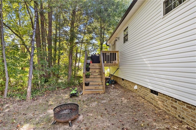 view of yard with an outdoor fire pit and a deck