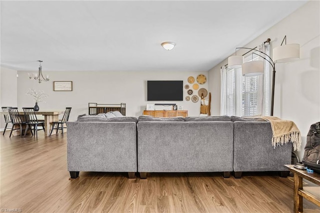 living room with an inviting chandelier and hardwood / wood-style floors