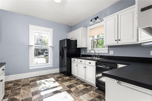 104 E Wilson St, Mebane, NC 27302 - kitchen with a sink, black appliances, dark countertops, and a textured ceiling