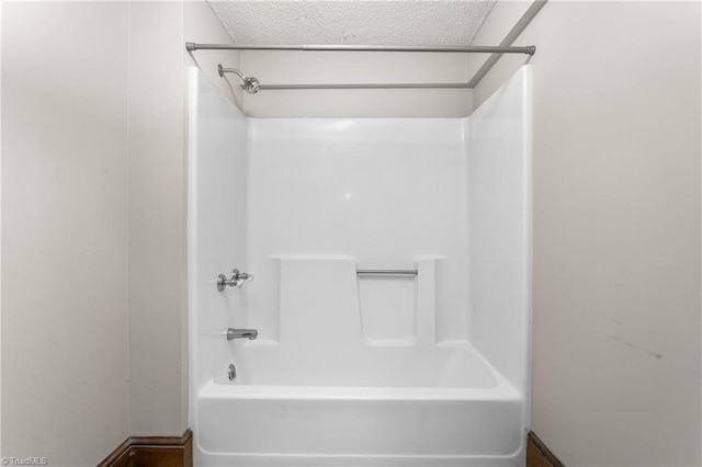 104 E Wilson St, Mebane, NC 27302 - bathroom with a textured ceiling and shower / bath combination